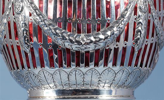 A Victorian silver swing handled sugar basket with cranberry glass liner, length 128mm, weight silver only 5.3oz/151grms